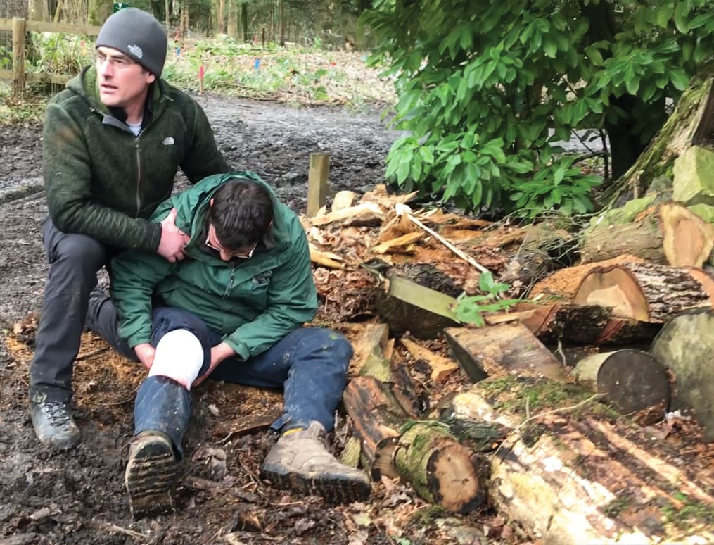 a man using a bandage whilst on an arb specific first aid course